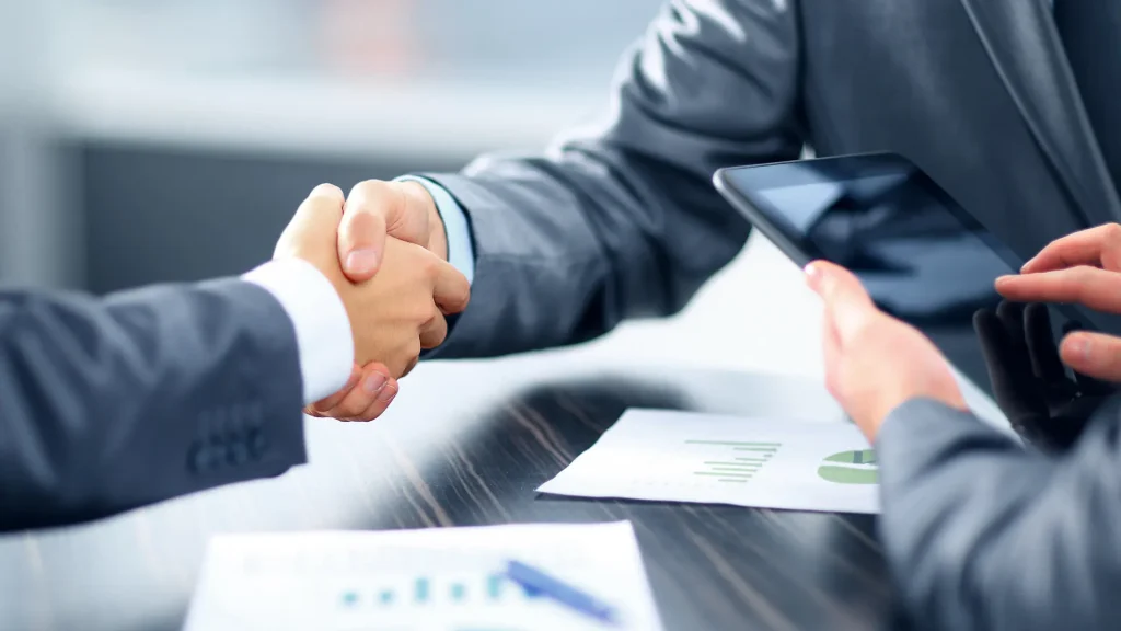 Handshake after the achievement of business agreement